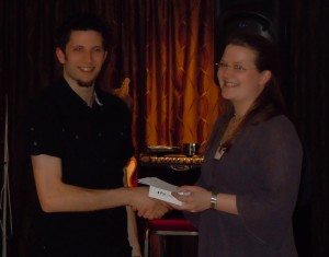 Kirsten presents Nick with his prize